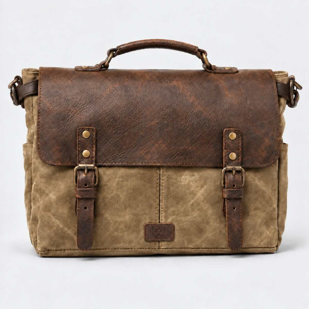 A rustic leather and canvas messenger bag with a distressed brown leather top flap, buckle straps, a top handle, and a tan canvas body, shown against a light gray background.